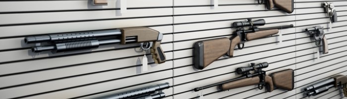 Guns hanging on the wall of a gun store