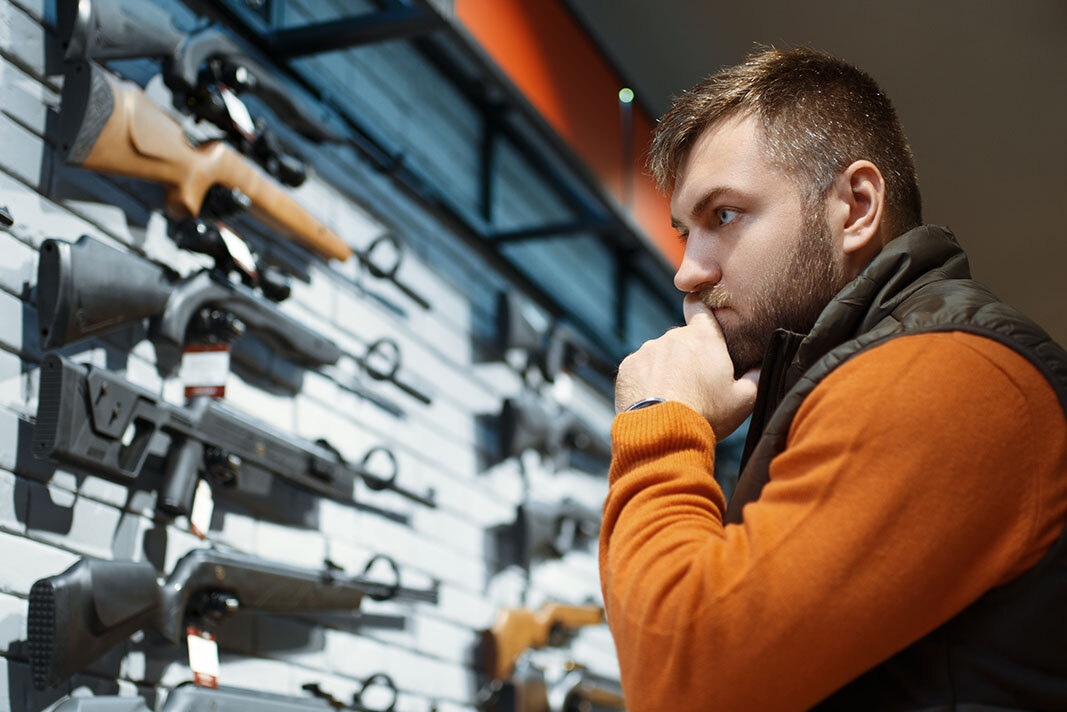 Man shopping for firearms.