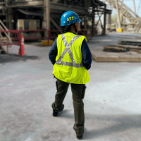 Janisett De La Caridad Ortegoza working outdoors in protective gear.