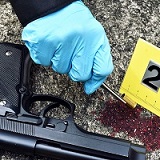 A gun and blood at a crime scene