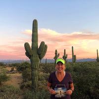 Nicole standing in front of a tall cactus