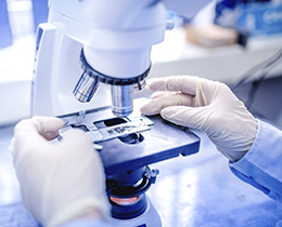 Scientist using a microscope