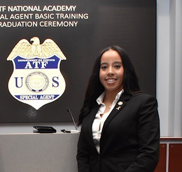 Mariah posing in front of a large ATF badge