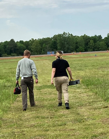 Sonia walking in a field with a colleague