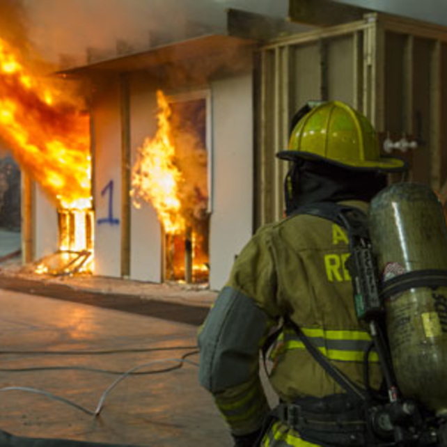 Certified fire investigator trainee observing a controlled fire during training