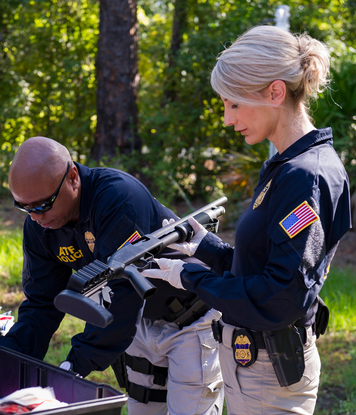 Katherine inspecting a firearm