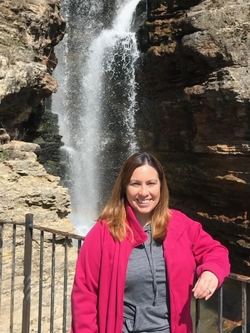 Misty standing in front of a waterfall